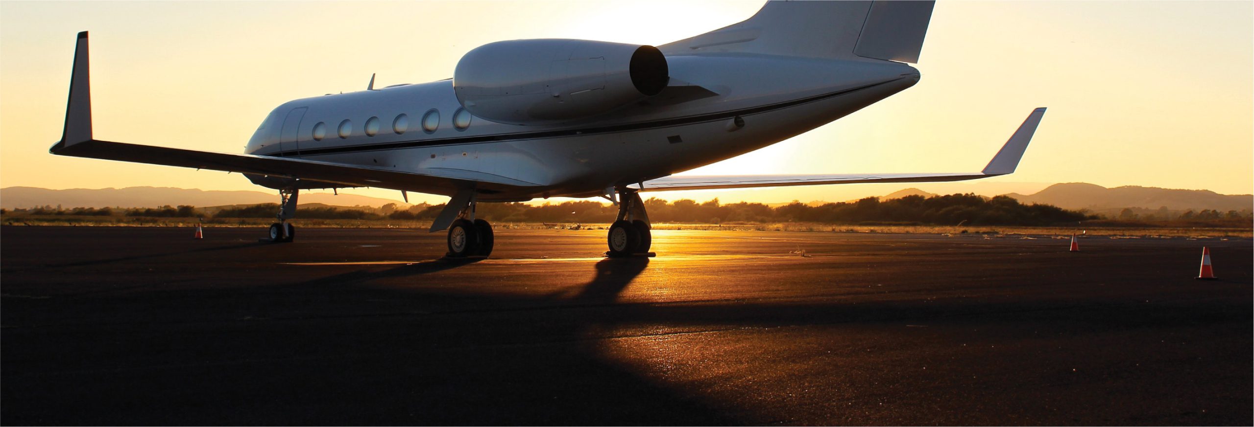 small private plan on the runway at sunset