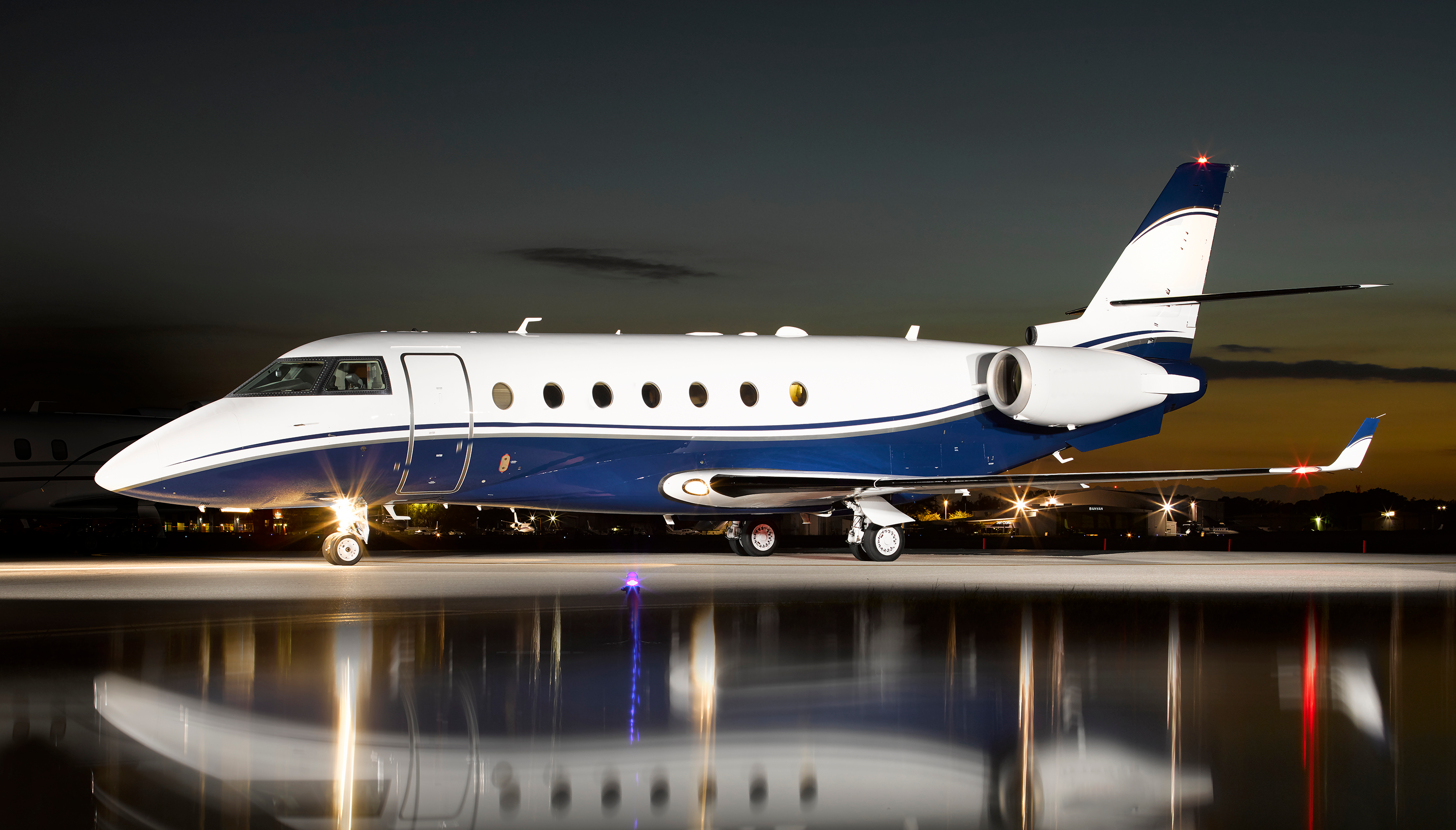 small private jet on runway at night