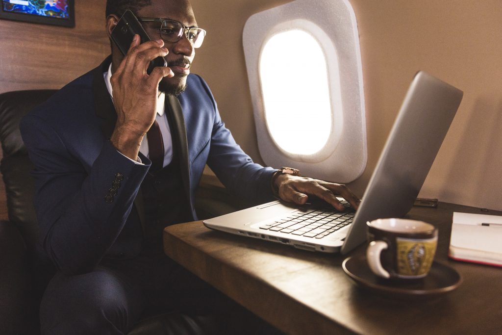 business man on cell phone while on a private aircraft