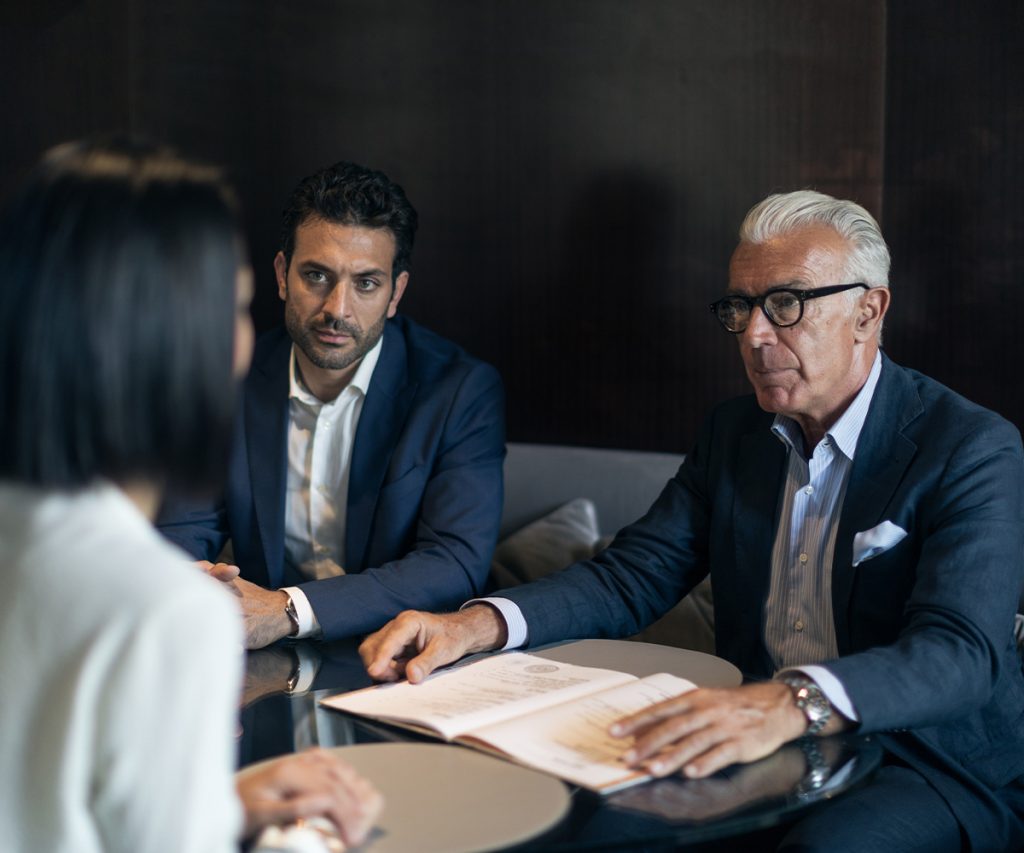 two businessmen meeting with a woman